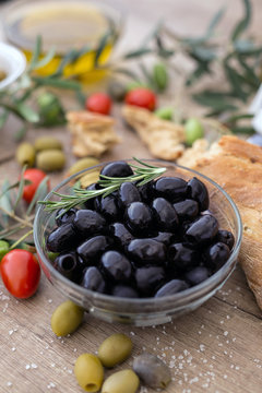 Greek black olives in the bowl served for snack.
