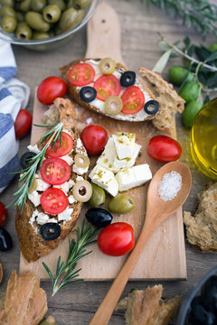 Italian bruschetta with tomatoes, mozzarella cheese, olives and fresh vegetables.
