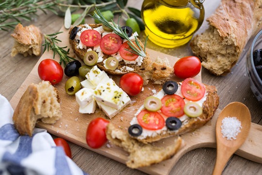 bruschetta with tomatoes, mozzarella cheese, olives and fresh vegetables.