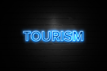 Tourism neon Sign on brickwall