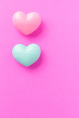 Two heart shapes over purple color table. Valentine Day concept.