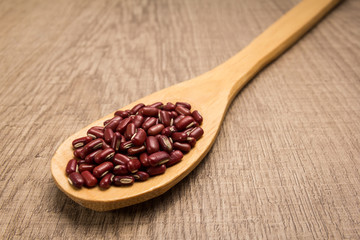 Adzuki Bean legume. Spoon and grains over wooden table.