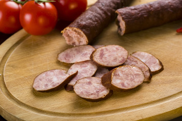 Sandwiches with homemade smoked sausage located on a board - food for consolation - tasty and healthy