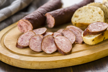 Sandwiches with homemade smoked sausage located on a board - food for consolation - tasty and healthy