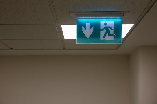 Green Emergency Exit Sign On White