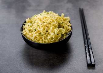 noodles in a bowl with broth and chopsticks