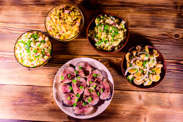 Different festive dishes on a wooden table. Top view