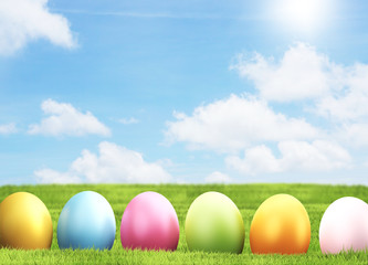 Easter eggs 3d rendering green grass blades of grass meadow blue sky