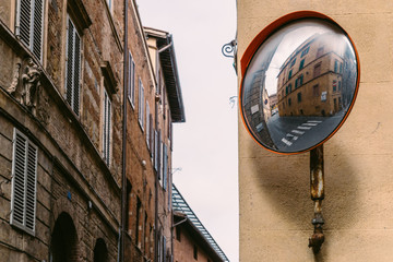 Reflector on empty rustic Italian street corner