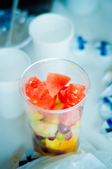 refreshing dessert, cup with tropical fruit on a table