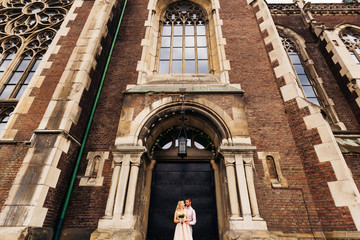 happy couple on the background of a chic building with beautiful architecture windows