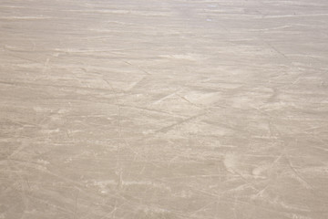 Detail of an empty ice rink, but with obvious signs of skates.
