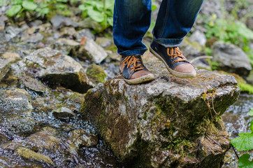 Adult's feet walk along the mountain path