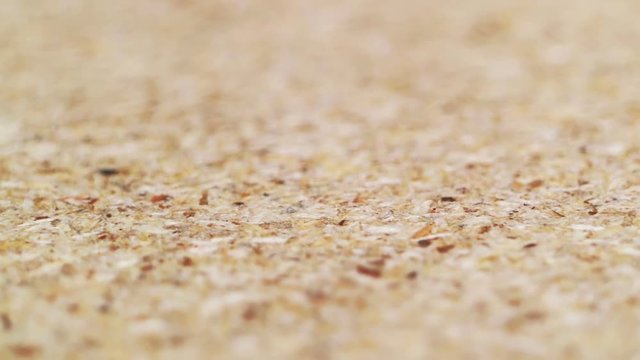 Chipboard texture close-up. Smooth rotation. Quality control in furniture production. Paperboard.