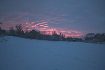 Winter snowy morning dawn in the countryside.