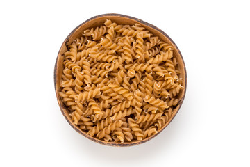 Uncooked wholemeal pasta isolated white background.