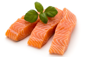 Fresh salmon fillet with basil on the white background.