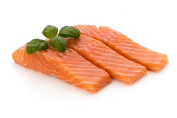 Fresh salmon fillet with basil on the white background.