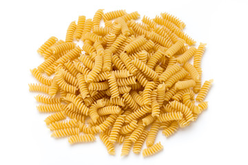 Uncooked fusilli pasta isolated white background.