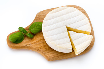 Piece of camembert cheese isolated on white background. From top view.