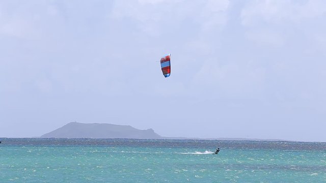 PORT LOUIS, MAURITIUS , Young man kitesurfing in ocean, extreme summer sport