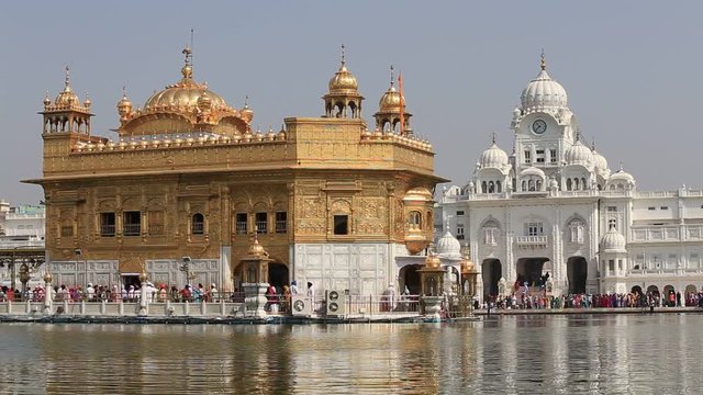 AMRITSAR, INDIA - SEPTEMBER 29, 2014: Unidentified Sikhs and indian people visiting the Golden Temple in Amritsar, Punjab, India. Sikh pilgrims travel from all over India to pray at this holy site.
