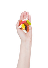 Female hand hold gummy color candies with sugar