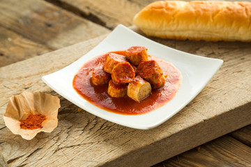 Chicken curry sausages served on plate.