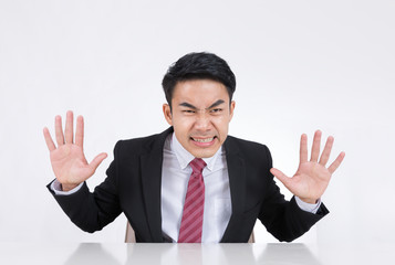 Portrait of a angry businessman at office isolated on white background.