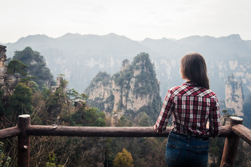 Fototapeta na wymiar Traveler standing and watching on the wonderful view of mountains at China