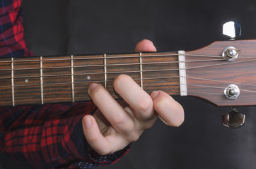  Musician Playing accord Dm on acoustic guitar, close up