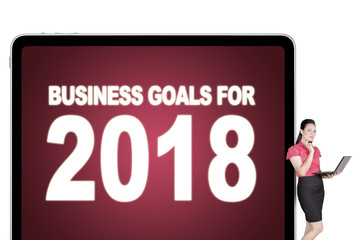 Businesswoman with text of business goals for 2018