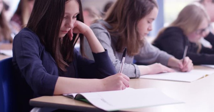 4k, A young girl in a classroom concentrating on her test
