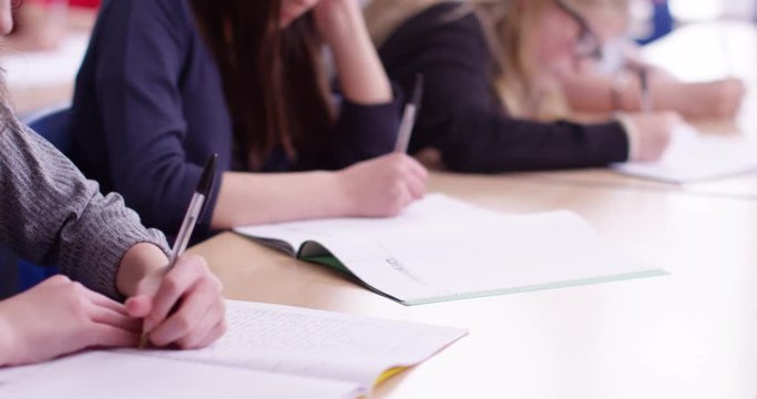 4k, young students writing in a classroom.