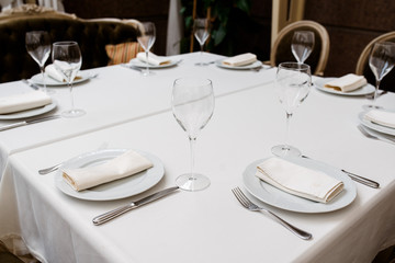 Beautiful table setting, with glasses and utensils.