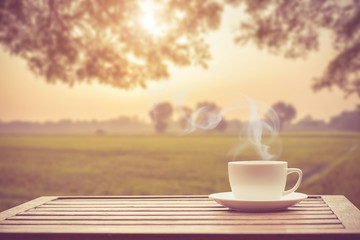 Naklejka na ściany i meble Coffee espresso on wood table nature background in garden,warm tone