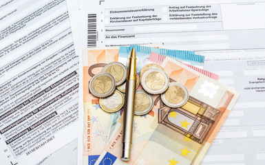 Money and pen on the German tax form. Top view. 