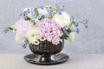 Floral arrangement with pink peonies, ranunculus flowers