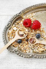Two wooden spoons with muesli.