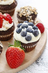 Muffins decorated with fresh fruits and oatmeal flakes. Healthy snack.