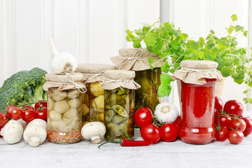 Jars of preserves and fresh vegetables.