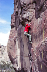 Climber on steep basalt face