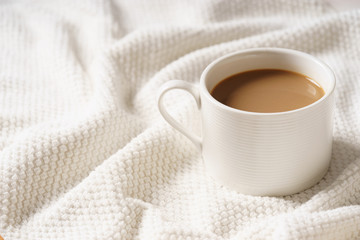 Obraz na płótnie Canvas coffee cup and bread in bed, cozy breakfast