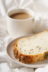 coffee cup and bread in bed, cozy breakfast