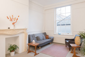 Apartment Living Room Interior with Vintage Furniture and Sealed Fireplace