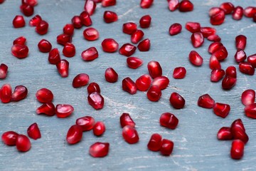 seeds of pomegranate on blue wooden background