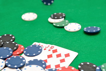 A royal flush displayed with poker chips. Shallow depth of field