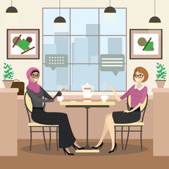 fashion caucasian and arab female  is sitting at a table in cozy restaurant