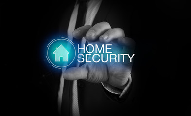 Businessman takes a hand home icon with inscription home security concept