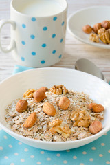 Healthy breakfast of muesli with nuts, honey and milk